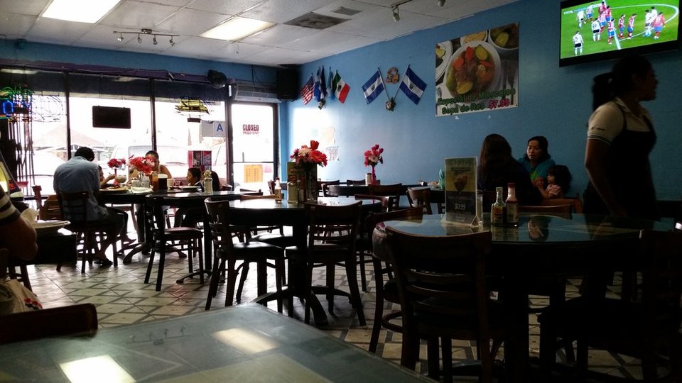 Casual Salvadoran restaurant dining room with simple tables.